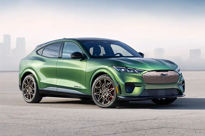 Front view of the Ford Mustang Mach-E electric SUV, showcasing its sleek grille-less design and signature Mustang headlights