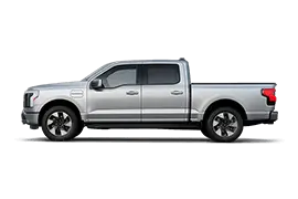 ALT: Ford F-150 Lightning electric truck side profile, demonstrating its full-size dimensions and functional bed.
