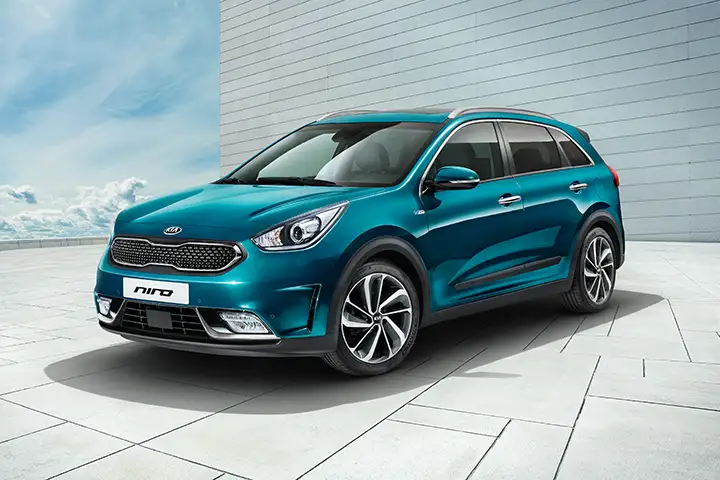 Front view of the KIA Niro EV (2018-2022), showcasing its distinctive "tiger-nose" grille with integrated charging port, compact electric SUV design, and efficient FWD electric powertrain with 150 kW (204 hp) output.