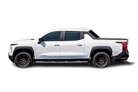 Side profile of the Chevrolet Silverado EV RST or Trail Boss trim, highlighting long 145.7-inch wheelbase, crew cab design, adaptive air suspension, and 493-mile EPA range.