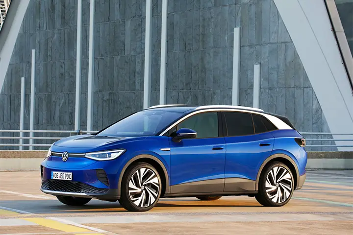 Front view of the 2024 Volkswagen ID.4 electric SUV with illuminated VW badge, upgraded APP550 motor (282 hp), and EPA range up to 291 miles.