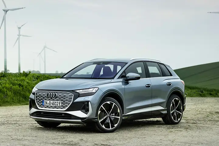 Front view of the Audi Q4 e-tron electric SUV with signature LED daytime running lights, single-frame grille, and aerodynamic fascia on the MEB 400V platform