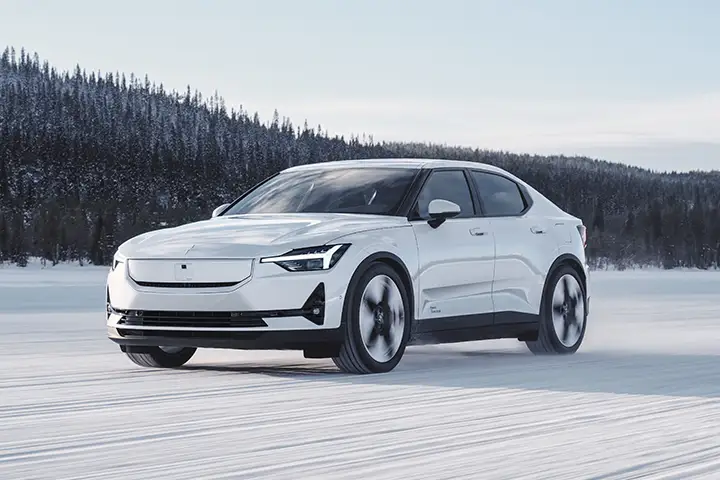 Front view of 2024 Polestar 2 fastback with SmartZone sensors, updated LED headlights and aerodynamic design supporting 205 kW DC charging.